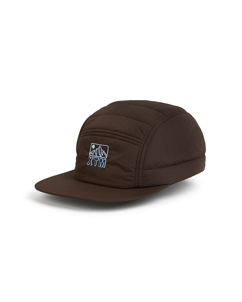 XTM Alpine Puffer Cap in Java, a chocolate brown quilted cap with embroidered mountain badge on the front