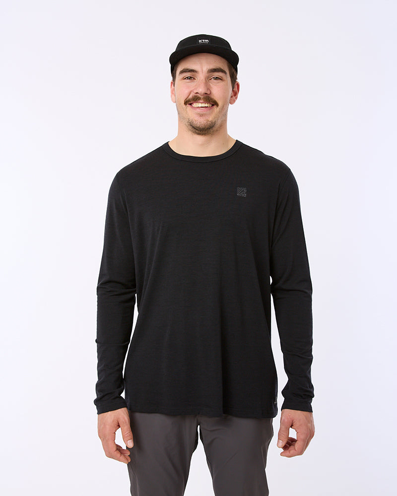 Model wearing the black XTM Adventure170 merino long sleeve thermal shirt, front view