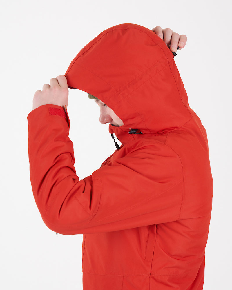 Boy pulling the peaked hood of the Lava XTM Kids Titanium III Snow Jacket over his head