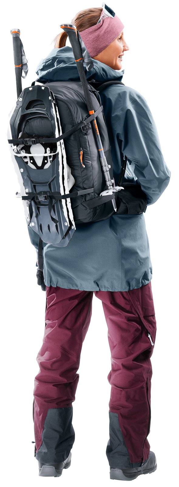 Woman wearing the Deuter Freerider 28 SL with snowshoes attached to the front