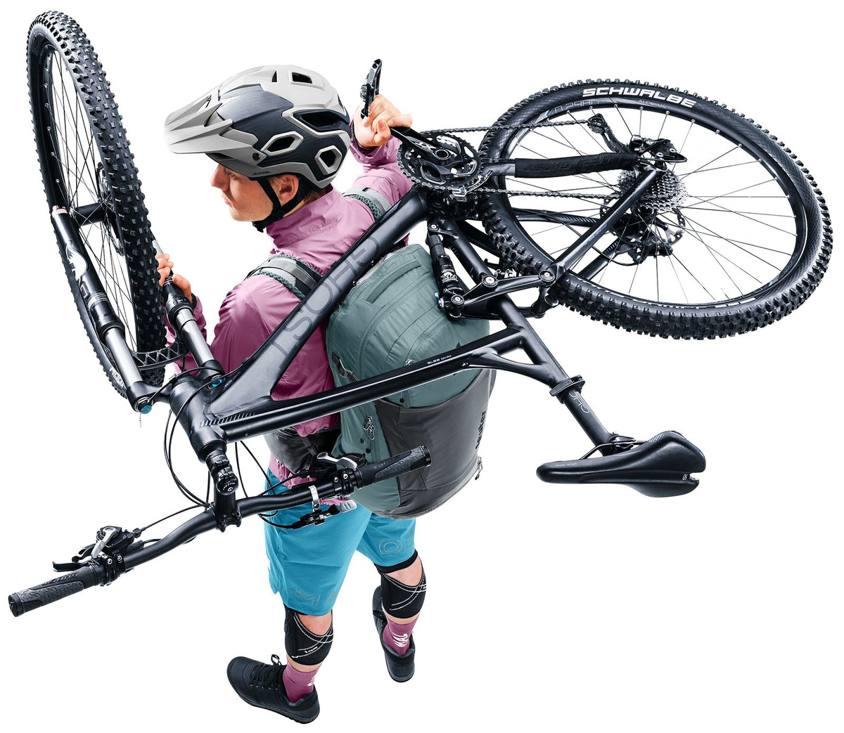 Mountain biker shouldering a bike over the Deuter Trans Alpine Pro 28 Carrying Guard