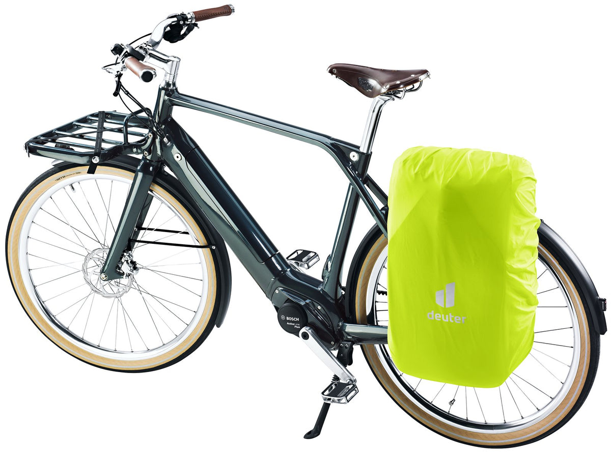 Deuter Xberg 25 on a bike rack with its neon yellow rain cover fitted