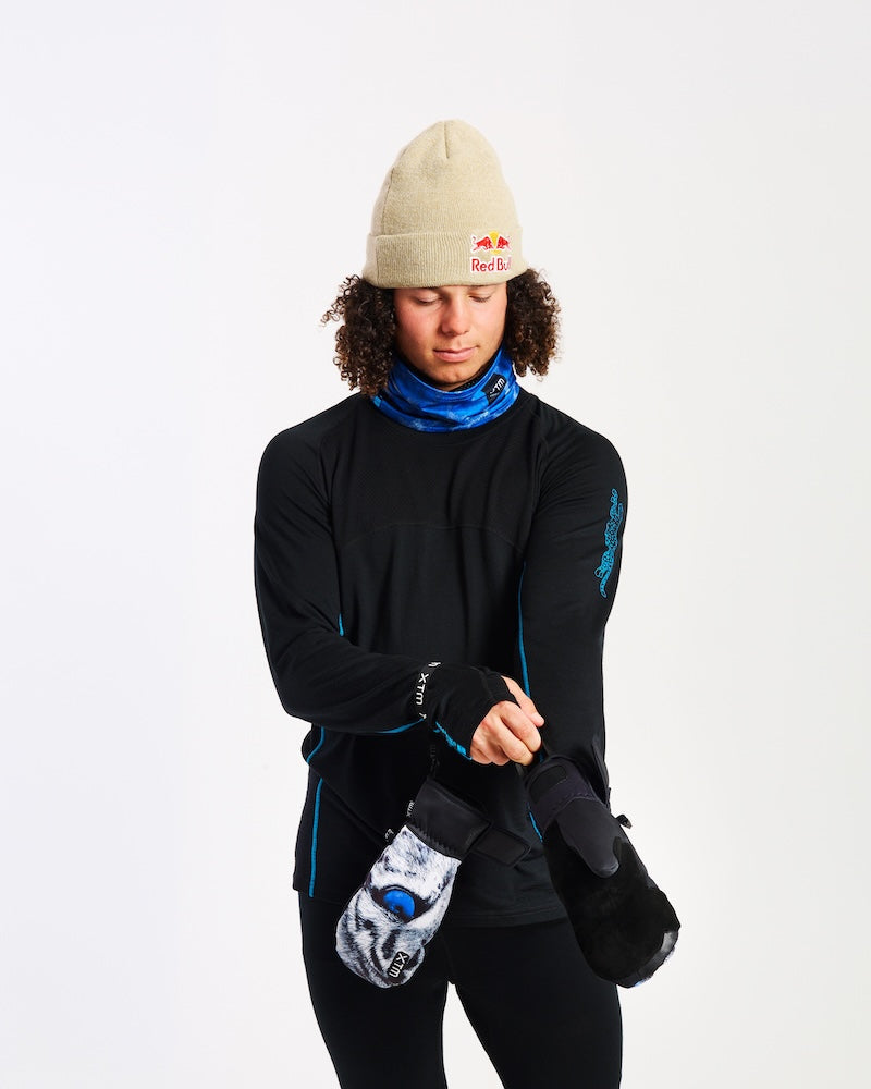 Model pulling on an XTM Valentino Ascent mitt with the black velcro cuff and wrist leash