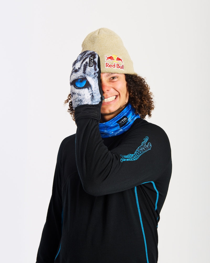 Smiling rider covering one eye with an XTM Valentino Ascent Snow Leopard print mitt