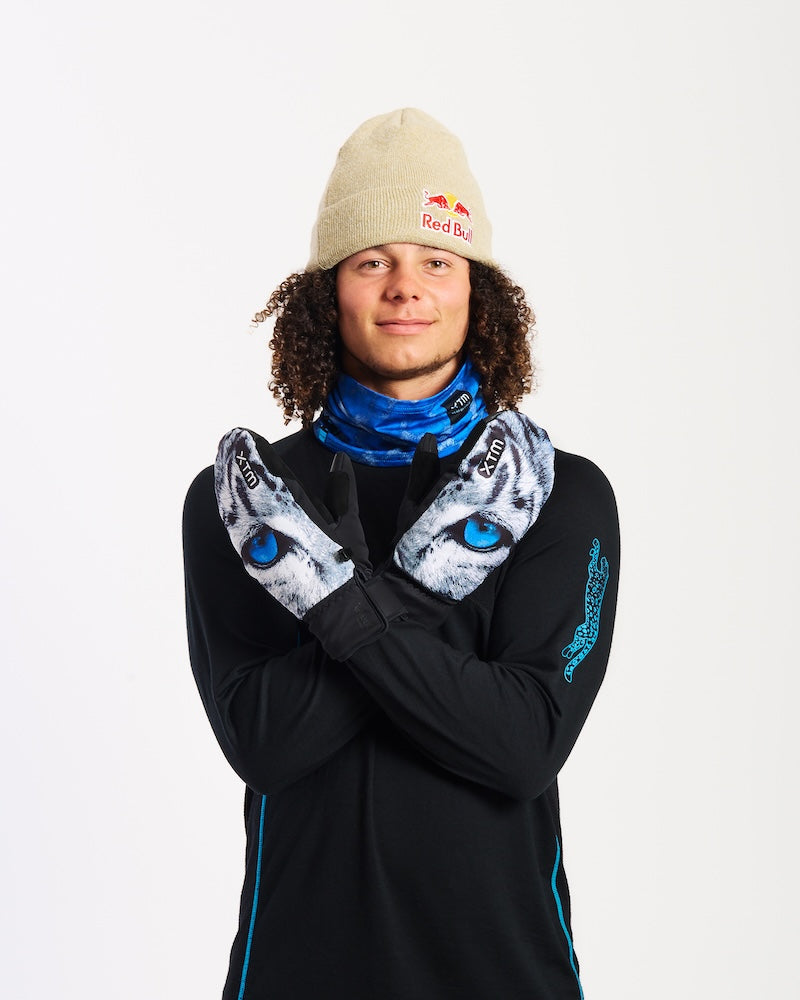 Snowboarder in a beanie crossing his arms wearing XTM Valentino Ascent Snow Leopard mitts