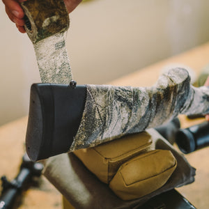 Camo Form being wound around a rifle stock just ahead of the recoil pad