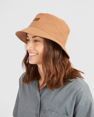 Smiling woman in the Woodsmoke XTM Sundew bucket hat, side view showing an eyelet vent
