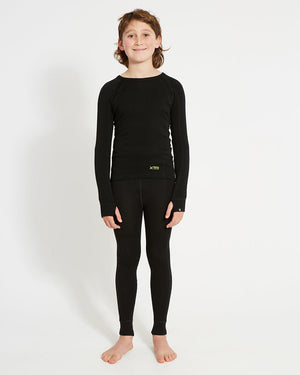 XTM Kids Alpine230 Merino Thermal Pants in Black, full-length view on a boy wearing a matching thermal top