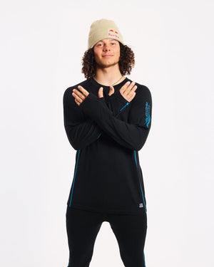 Model crossing arms in the XTM Valentino Active200 merino top, showing the sleeve print