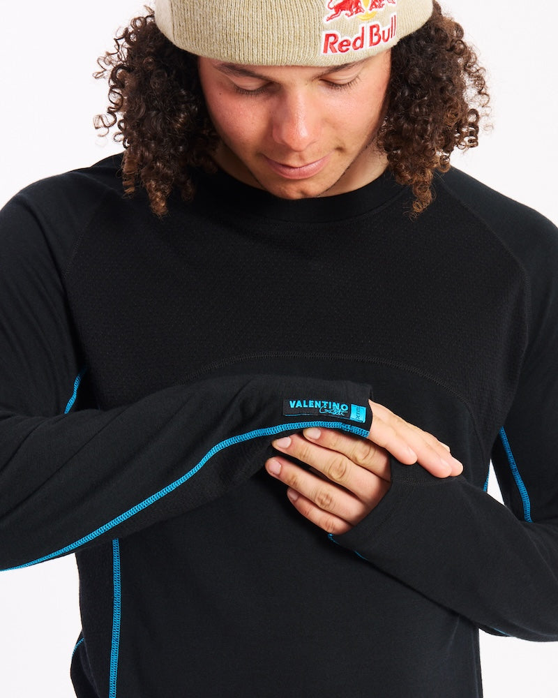 Close-up of a thumb loop and Valentino label on the cuff of the XTM Active200 merino top