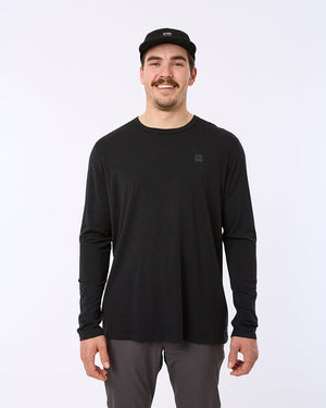 Model wearing the black XTM Adventure170 merino long sleeve thermal shirt, front view