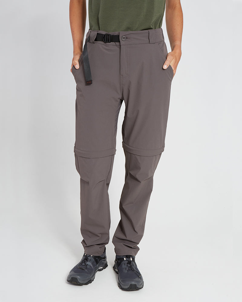Woman wearing XTM Wye River zip-off hiking pants in Pavement grey with black belt, front view