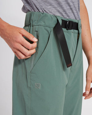Close-up of the concealed zip stash pocket being opened on XTM Wye River Spruce Green pants