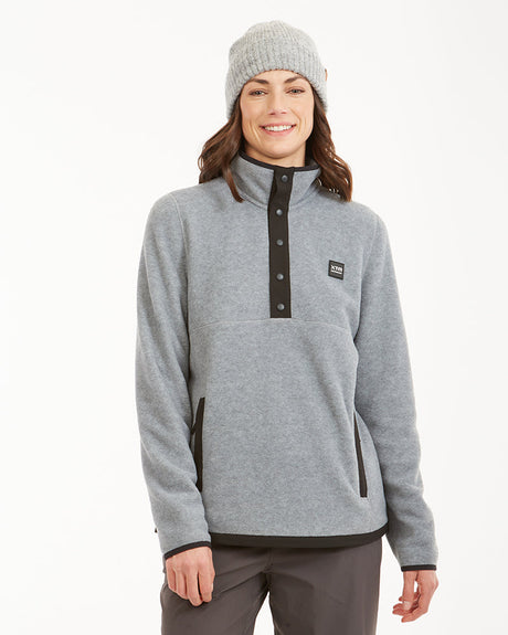 Woman wearing XTM Shelly fleece pullover in Light Grey Marle, front view with black snap placket