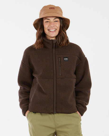 Woman wearing XTM Banksia sherpa fleece jacket in Java chocolate brown with bucket hat, front view