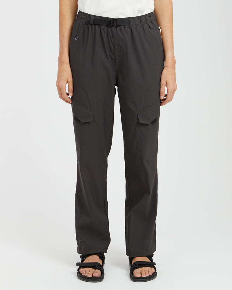 Woman wearing XTM Acacia hiking pants in Pirate Black with belt and leg flap pockets, front view