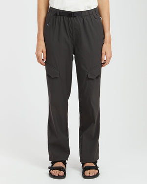 Woman wearing XTM Acacia hiking pants in Pirate Black with belt and leg flap pockets, front view