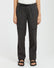 Woman wearing XTM Acacia hiking pants in Pirate Black with belt and leg flap pockets, front view