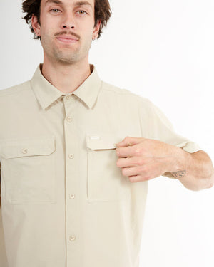 Hand opening the chest pocket on the Sand XTM Dunkeld short sleeve shirt