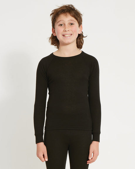 XTM Kids Heatflex Thermal Top in Black, front view on a boy showing the crew neck