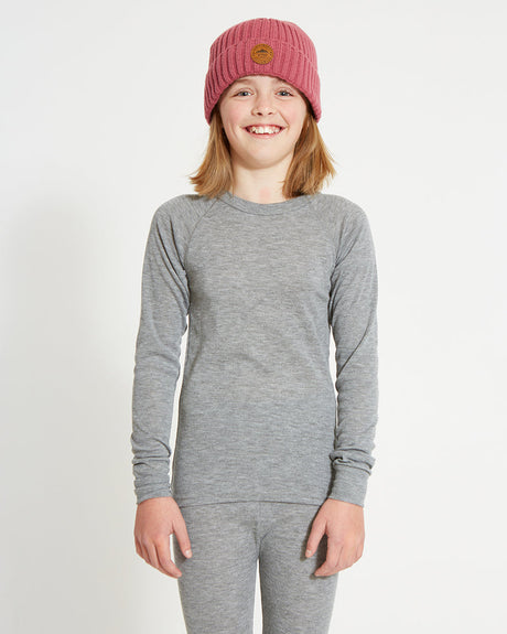 XTM Kids Heatflex Thermal Top in Charcoal Marle, front view on a girl in a pink beanie