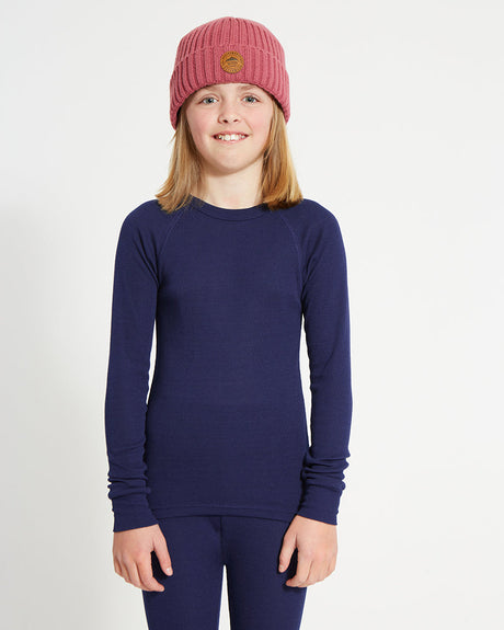 XTM Kids Heatflex Thermal Top in Navy, front view on a girl in a pink beanie