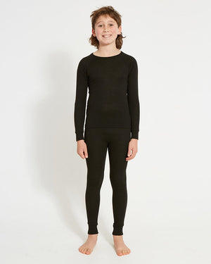 XTM Kids Heatflex Thermal Pant in Black, full-length view on a boy with a matching top