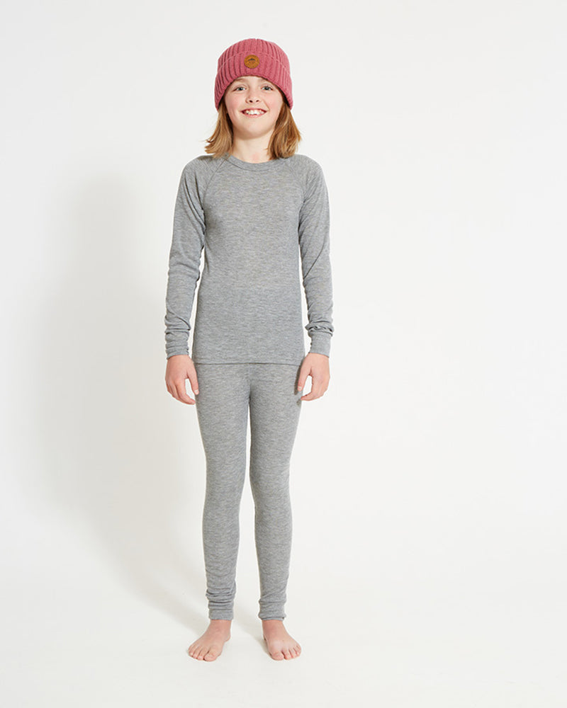 XTM Kids Heatflex Thermal Pant in Charcoal Marle, full-length view on a girl with a matching top