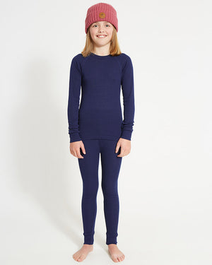 XTM Kids Heatflex Thermal Pant in Navy, full-length view on a girl with a matching top