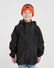 Boy wearing the XTM Kids Stash 2L rain jacket in Black, front view, zipped with hood rolled away