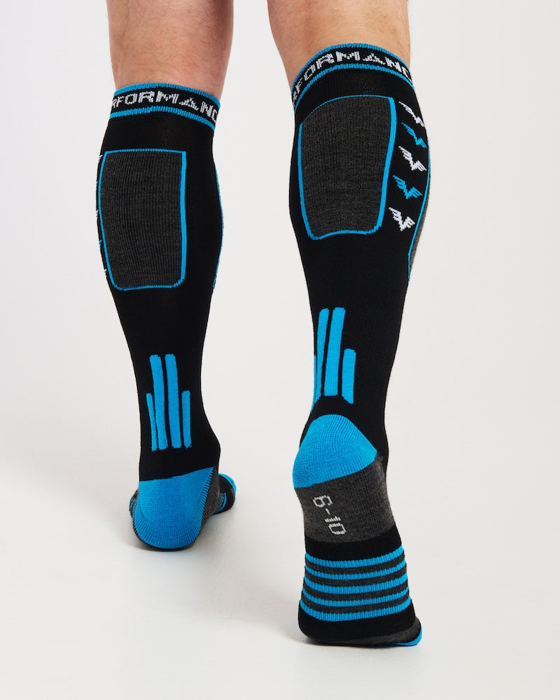 Back view of the black XTM Valentino snow socks worn, showing the blue heel and achilles detailing