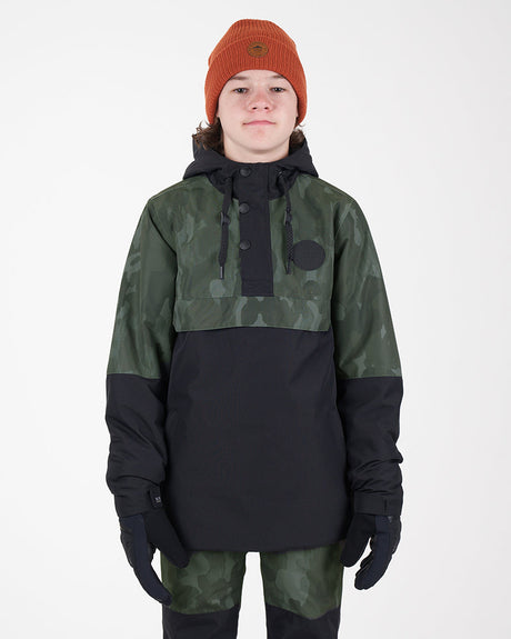 Boy wearing the Snowgum XTM Kids Riley Ski Jacket Anorak, green camo top and black body, front view