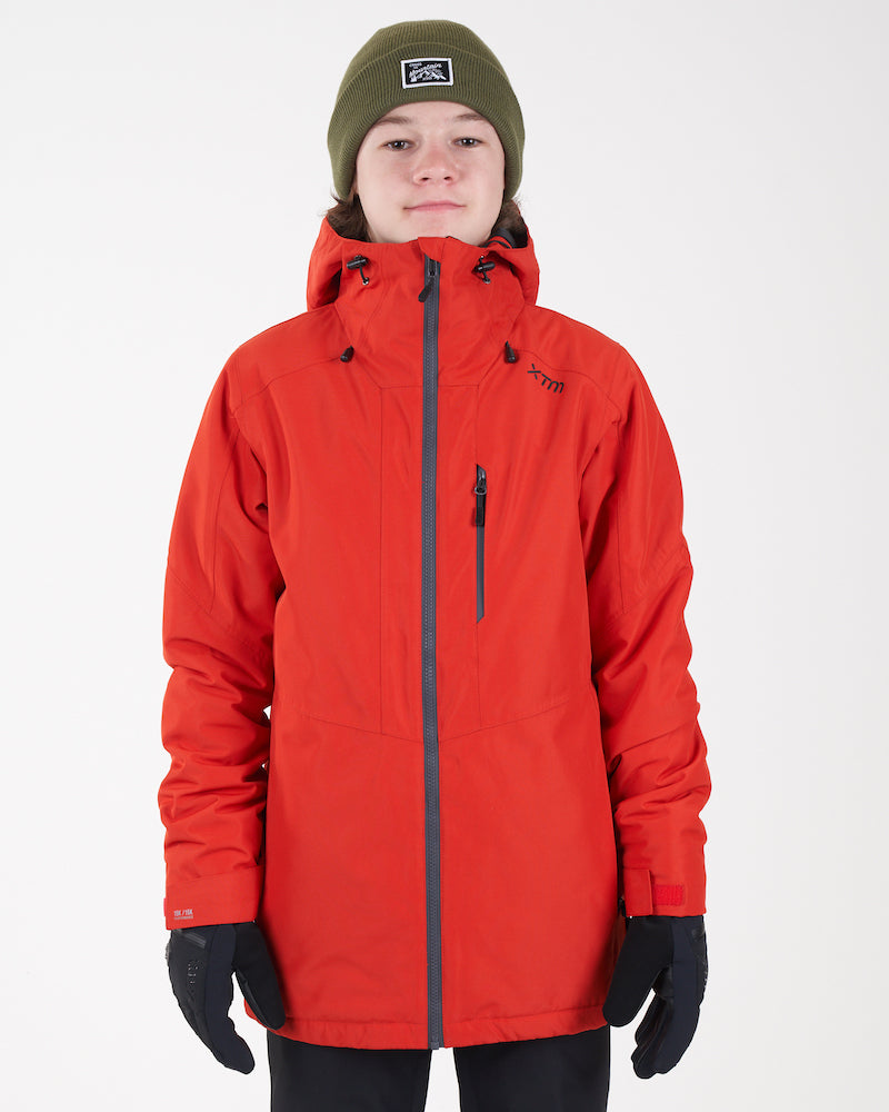 Boy wearing the Lava red XTM Kids Titanium III Snow Jacket, front view with grey zip and chest pocket