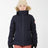 Girl wearing the Navy XTM Kids Pippa Ski Jacket zipped up, front view with fur-trimmed hood down