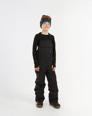 XTM Kids Bailey Ski Pant in Black, front view on a child, bib cut with shoulder straps