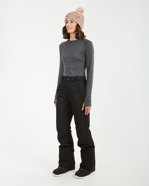 Three-quarter full-length view of a woman in the black XTM Smooch ski pants