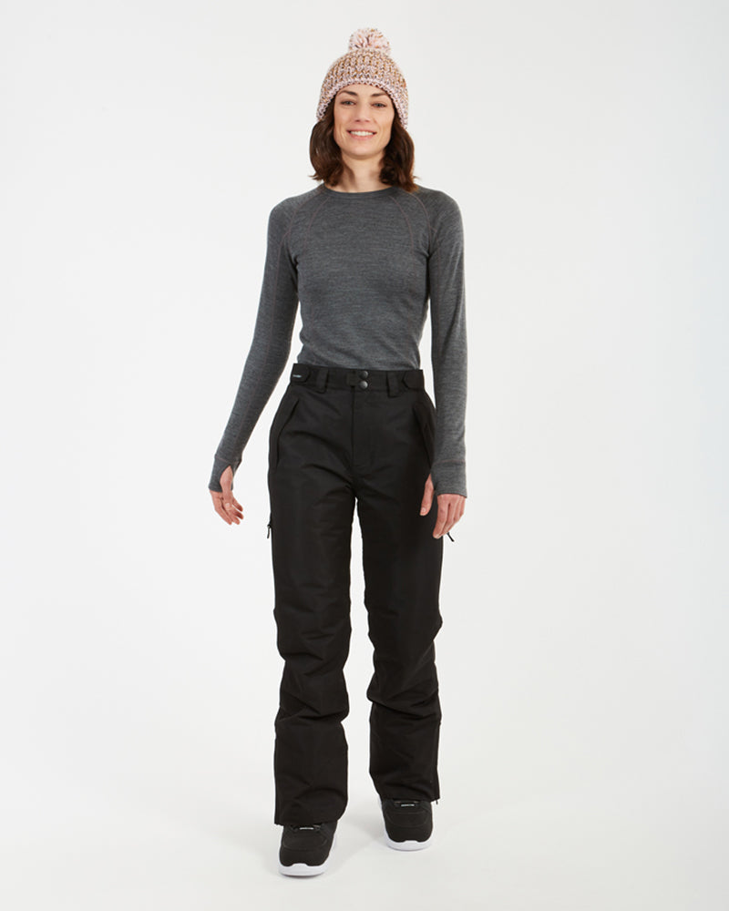 Woman in the black XTM Smooch ski pants and pink beanie, front view