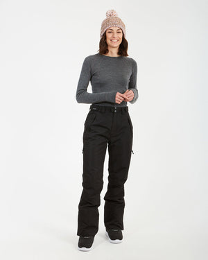 Woman smiling in the black XTM Smooch women's ski pants, full-length view