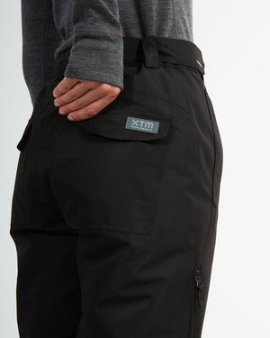 Close-up of the XTM-badged flapped back pocket on the black Smooch ski pants