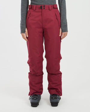 Front view of the XTM Smooch women's ski pants in Boysenberry worn with ski boots