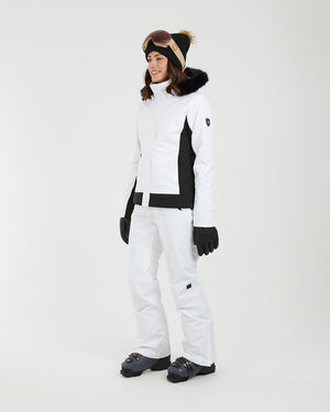 Three-quarter full-length view of a woman in the white XTM Solace ski jacket