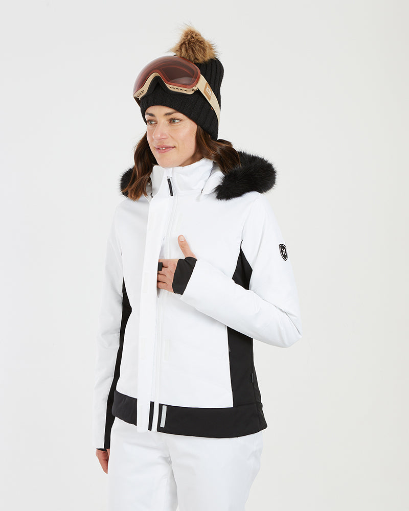 Close-up of a woman in the white XTM Solace jacket with a thumb-hole cuff at the chest
