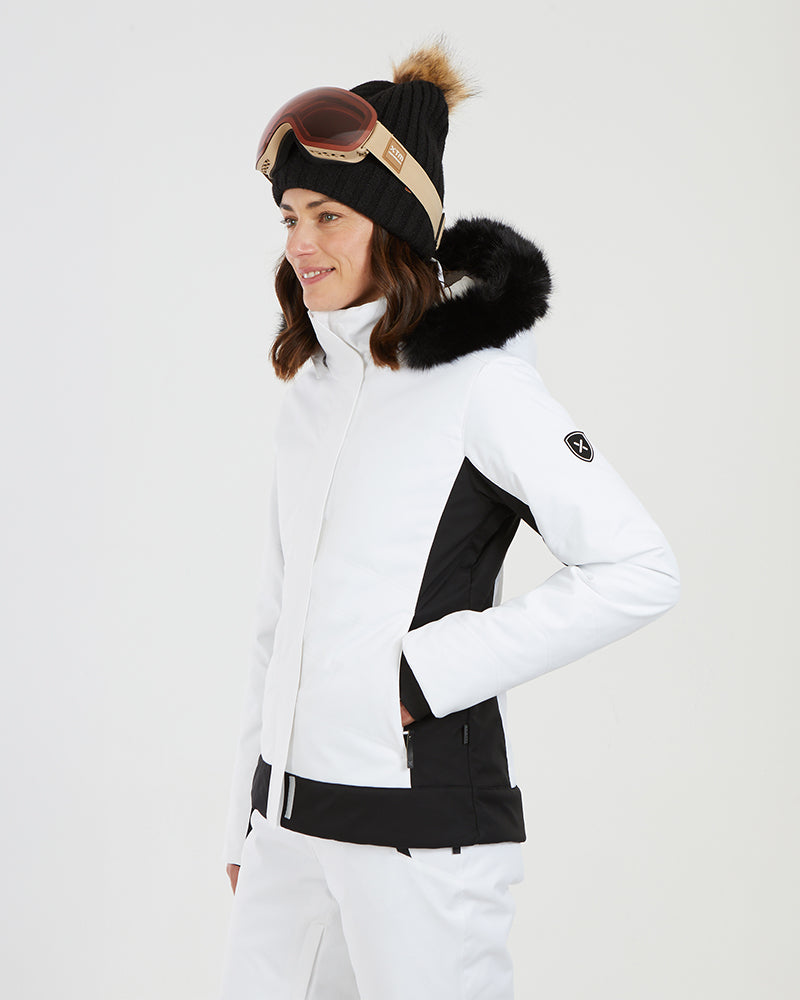 Three-quarter view of the white XTM Solace jacket with a hand in the hand warmer pocket