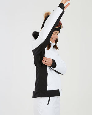 Woman raising her arm in the white XTM Solace jacket to show the underarm vent