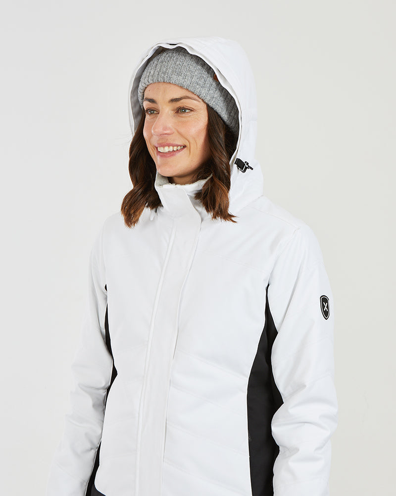 White XTM Solace jacket worn with the hood up and the faux fur trim removed