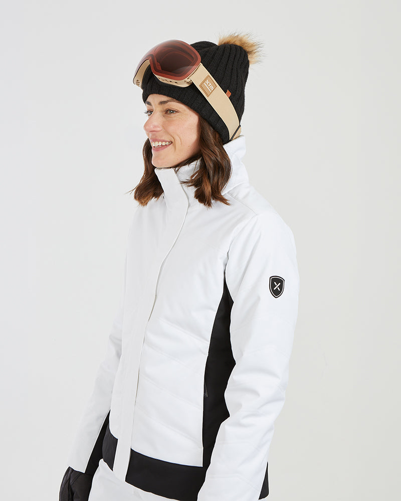 Close-up side view of the white XTM Solace collar and black sleeve badge