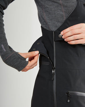 Close-up of the side zip and snap opening on the black XTM Stellar 2.0 bib