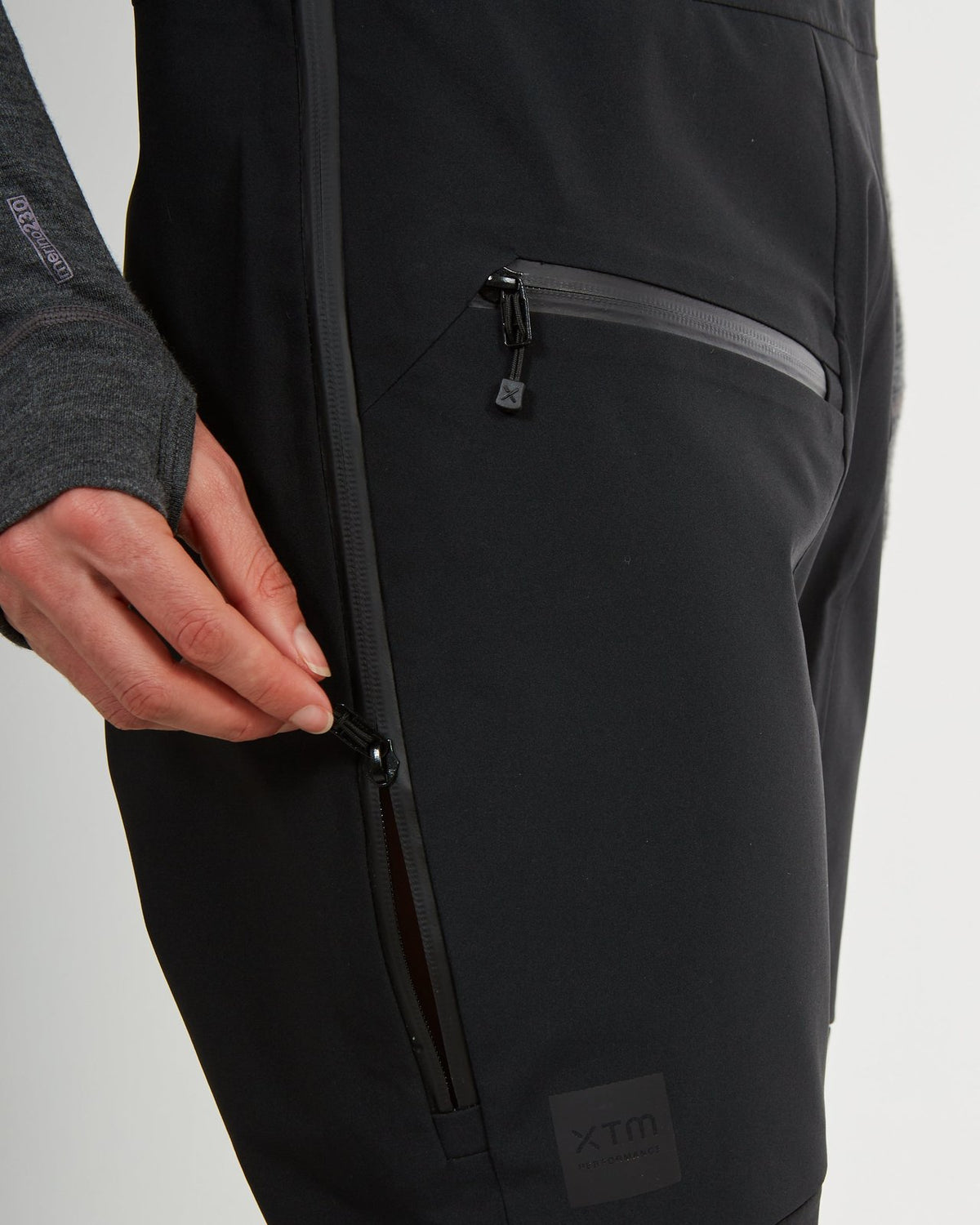 Close-up of the side zip and hip pocket on the black XTM Stellar 2.0 pant