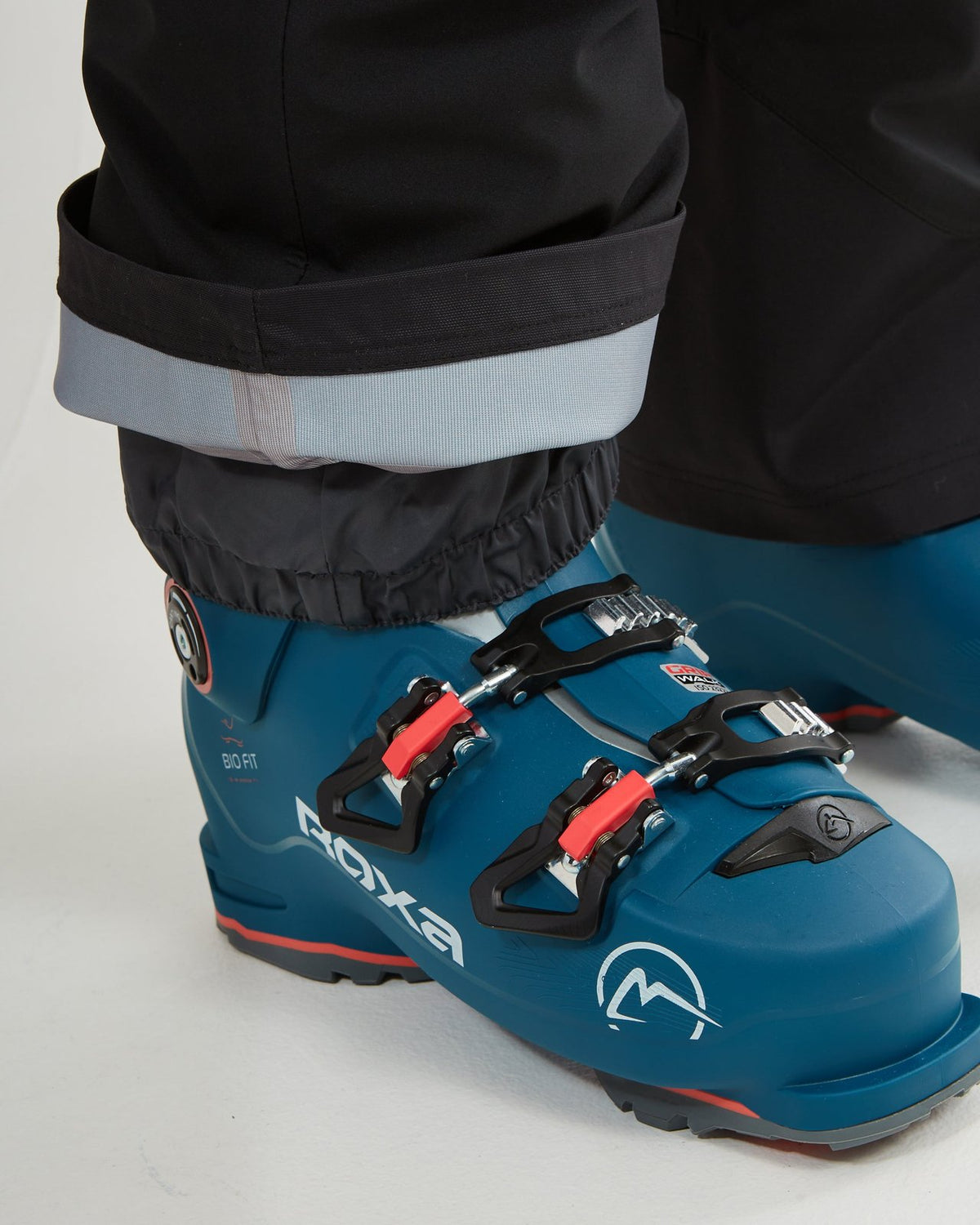 Black XTM Stellar 2.0 cuff rolled up over a ski boot, showing the boot gaiter
