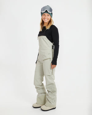 Three-quarter view of the Stone Grey XTM Stellar 2.0 bib showing the side zip